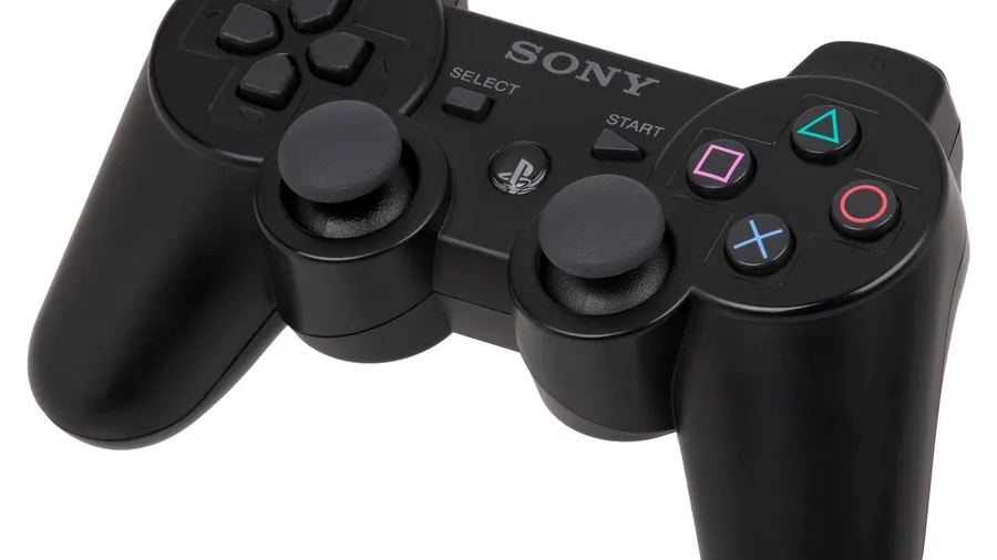 Black wired gamepad with two analog sticks and symbol face buttons