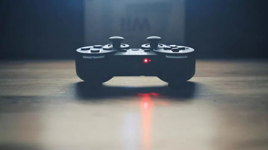 Game controller resting on a desk with a soft red light