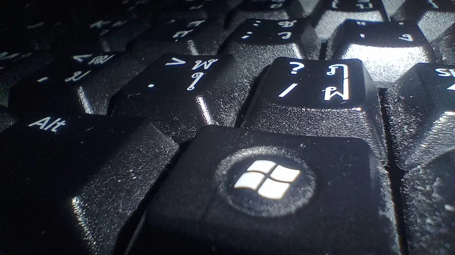 Close-up of a black keyboard with the Windows logo key in focus
